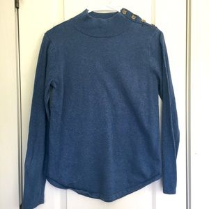 Blue sweater. Almost turtle neck